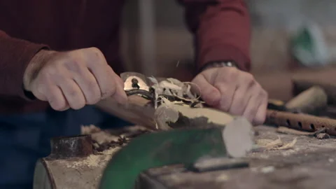 Slow Motion shot of a man using a manual wood planer tool Stock Footage 147104877