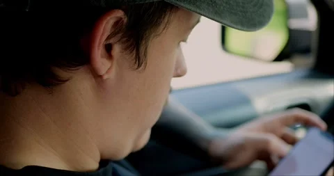 Slow-motion shot of man using smartphone inside car. Stock Footage 313951232