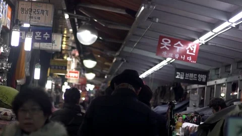 Slow motion shot of man walking down market alley in Namdaemun,Seoul,South Korea 스톡 동영상 84755732