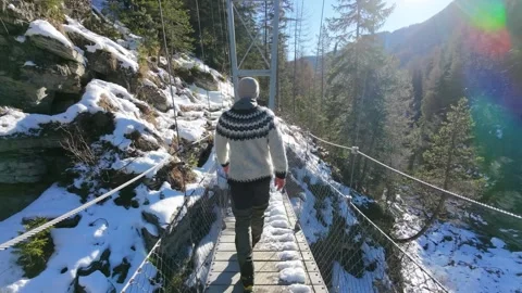 Slow Motion Shot of Man Walking Through Snowy Forest in Winter Video stock 326181387