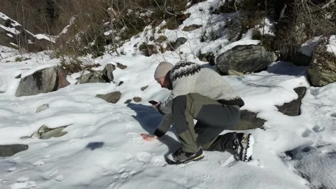 Slow Motion Shot of Man Walking Through Snowy Forest in Winter Video stock 326181417