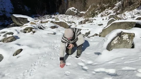 Slow Motion Shot of Man Walking Through Snowy Forest in Winter Stock Footage 326181423