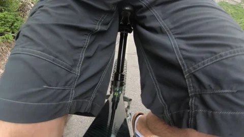 A slow motion shot of a mans legs while riding next to a mountain river Stock Footage 137640184