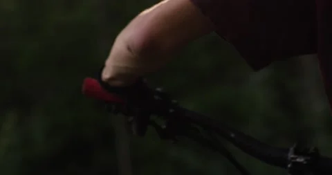Slow Motion Shot of a mountain biker pushing his bike Stock Footage 133433895