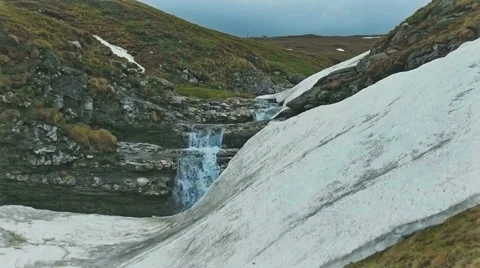 Slow motion shot of a mountain waterfall Stock Footage 63763314