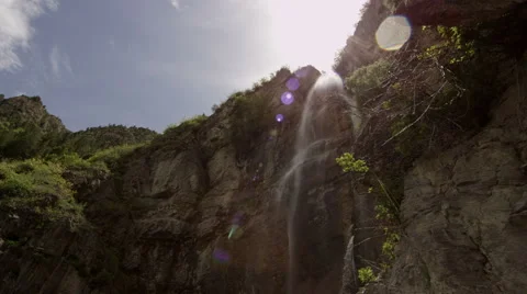 Slow motion shot moving towards waterfall and panning down Stock Footage 52498703