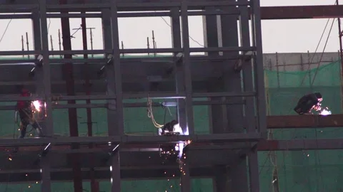 Slow motion shot of multiple welders welding on the outside of under Stock Footage 147246386