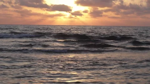 Slow motion shot of the ocean waves during sunset Stock Footage 313217009