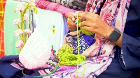 Slow-motion shot of Pakistani artist working on wool. Stock Footage 322632753