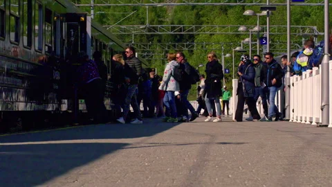 Slow motion shot of passengers queuing up and getting on a train at a Stock Footage 250934754