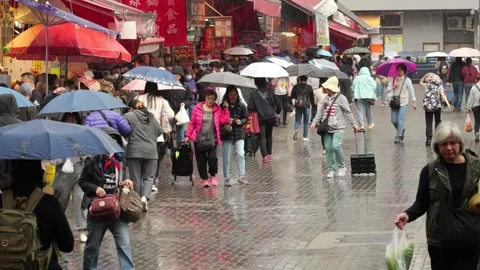 Slow motion shot of people walking with umbrellas at shopping Kai Man Path Vídeo Stock 341110503