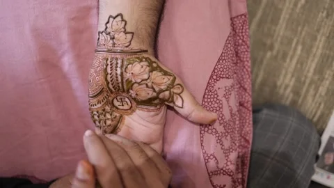 Slow Motion Shot of a person applying mehendi at an Indian Wedding Venue Stock Footage 169747342