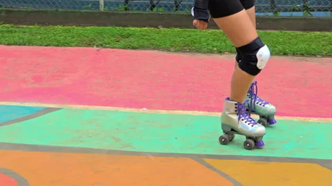 Slow motion shot of a person learning to rollerskate at Harry Struntz Park Stock Footage 305435628