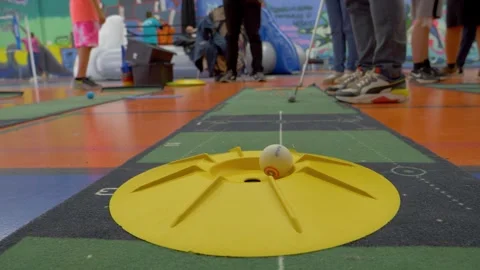 Slow motion shot of a person playing mini golf at the Narbonne Handicapped Stock Footage 249040347