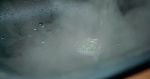 Slow motion shot, pouring boiled water into the sink, 4K Stock Footage 123548853