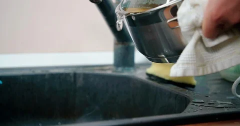Slow motion shot, pouring boiled water into the sink, 4K Stock Footage 123549293