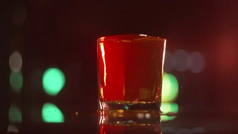 Slow Motion Shot of Pouring Whiskey into Glass with Camera Movement Stock Footage 225553659