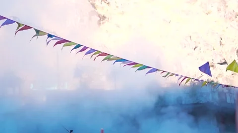 Slow motion shot of the prayer flags in front of the water vapor  Stock Footage 240905457