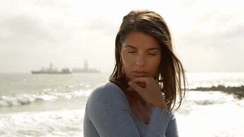 Slow Motion Shot of Pretty Model with Waves and Ocean in Background Stock Footage 115842818