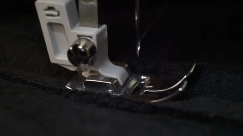 Slow motion shot of the process of sewing black fabric on the sewing machine Stock Footage 114620045