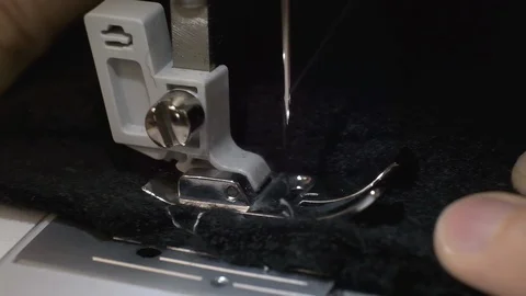 Slow motion shot of the process of sewing black fabric on the sewing machine Stock Footage 114620197