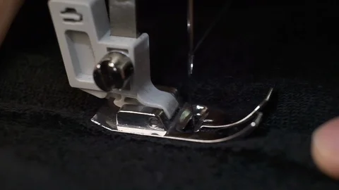 Slow motion shot of the process of sewing black fabric on the sewing machine Stock Footage 115335599