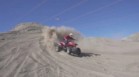 Slow motion shot of quad with big sand ejection front view Stock Footage 64670293