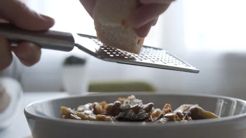Slow motion shot as rasping cheese on the top of the food. Stock Footage 124535100