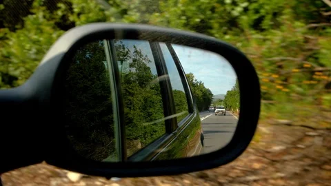 Slow motion shot of a rear view mirror while driving Stock Footage 119393376