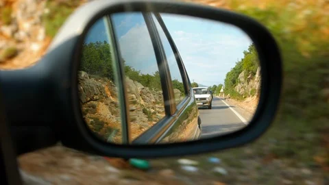 Slow motion shot of a rear view mirror while driving Stock Footage 119393425