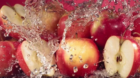Slow Motion Shot of Red Apple Water Splashing through Apple Slices Stock Footage 181846856