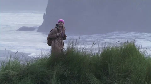 Slow motion shot on RED camera Woman at beach on cloudy rainy day, 6K USA travel 스톡 동영상 168146315