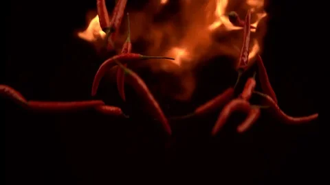 Slow Motion Shot of Red Chilli Peppers and Fire Explosion Stock Footage 123916243