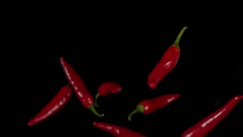 Slow Motion Shot of Red Chilli Peppers Explosion Stock Footage 140017280