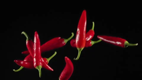 Slow Motion Shot of Red Chilli Peppers Explosion Stock Footage 140017596