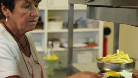 Slow Motion Shot of Restaurant Worker Placing Food Plates on Kitchen Pass Stock Footage 343765361