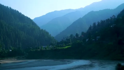 Slow motion shot of river with lush green mountains in hilly area of Pakista Stock Footage 200750795