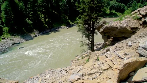 Slow motion shot of river with lush green mountains in hilly area of Pakista Stock Footage 200751289