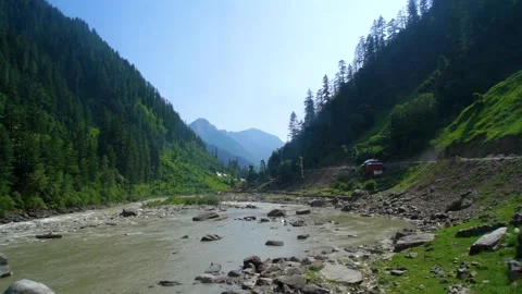 Slow motion shot of river with lush green mountains in hilly area of Pakista Stock Footage 200752861