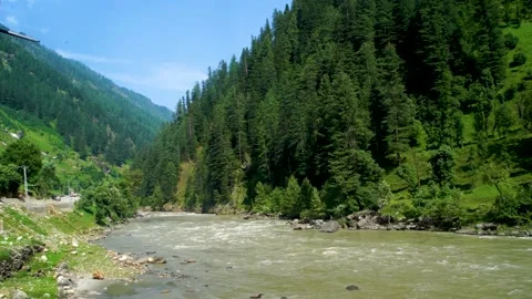 Slow motion shot of river with lush green mountains in hilly area of Pakista Stock Footage 200752862