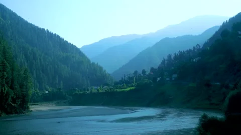 Slow motion shot of river with lush green mountains in hilly area of Pakista Stock Footage 200753038
