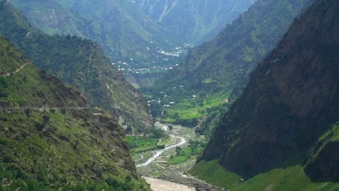 Slow motion shot of river with lush green mountains in hilly area of Pakista Stock Footage 200754011