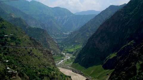 Slow motion shot of river with lush green mountains in hilly area of Pakista Stock Footage 200754012