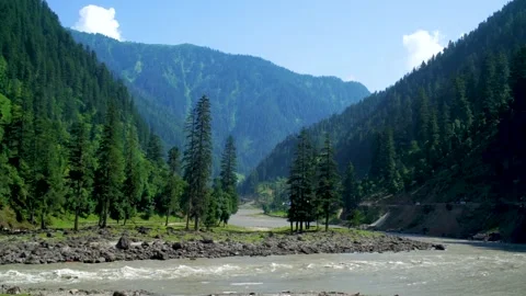 Slow motion shot of river with lush green mountains in hilly area of Pakista Stock Footage 200754407