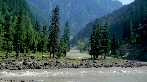 Slow motion shot of river with lush green mountains in hilly area of Pakista Stock Footage 200754408