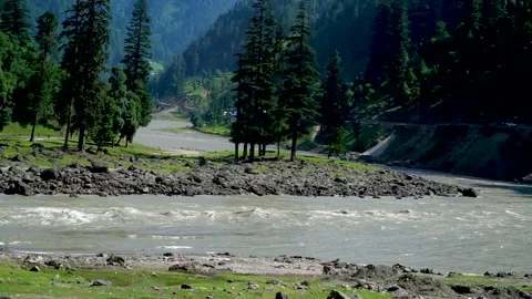 Slow motion shot of river with lush green mountains in hilly area of Pakista Stock Footage 200754708