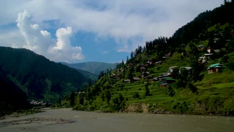 Slow motion shot of river with lush green mountains in hilly area of Pakista Stock Footage 200754997