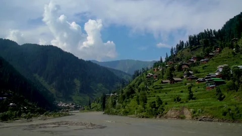 Slow motion shot of river with lush green mountains in hilly area of Pakista Stock Footage 200754998