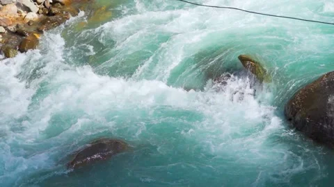 Slow motion shot of river Parvati flowing rapidly at Kasol in Himachal Pradesh Stock-Footage 229760839