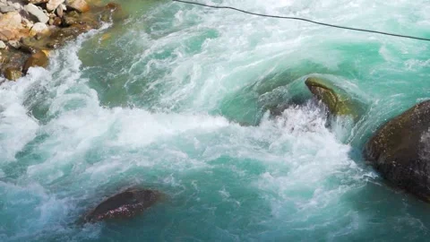 Slow motion shot of river Parvati flowing rapidly at Kasol in Himachal Pradesh Stock-Footage 229760860